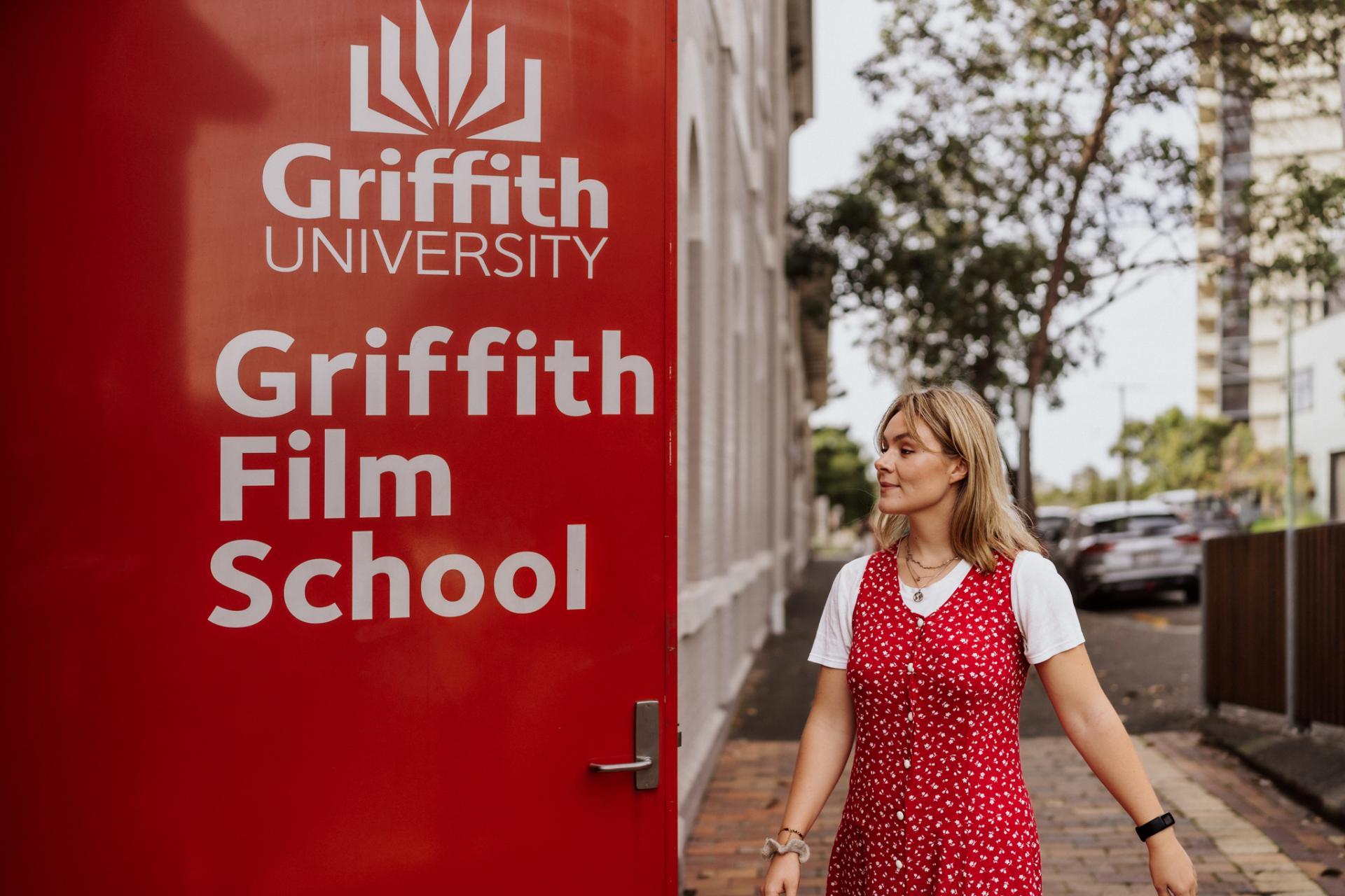 Female Griffith University student walking into campus.