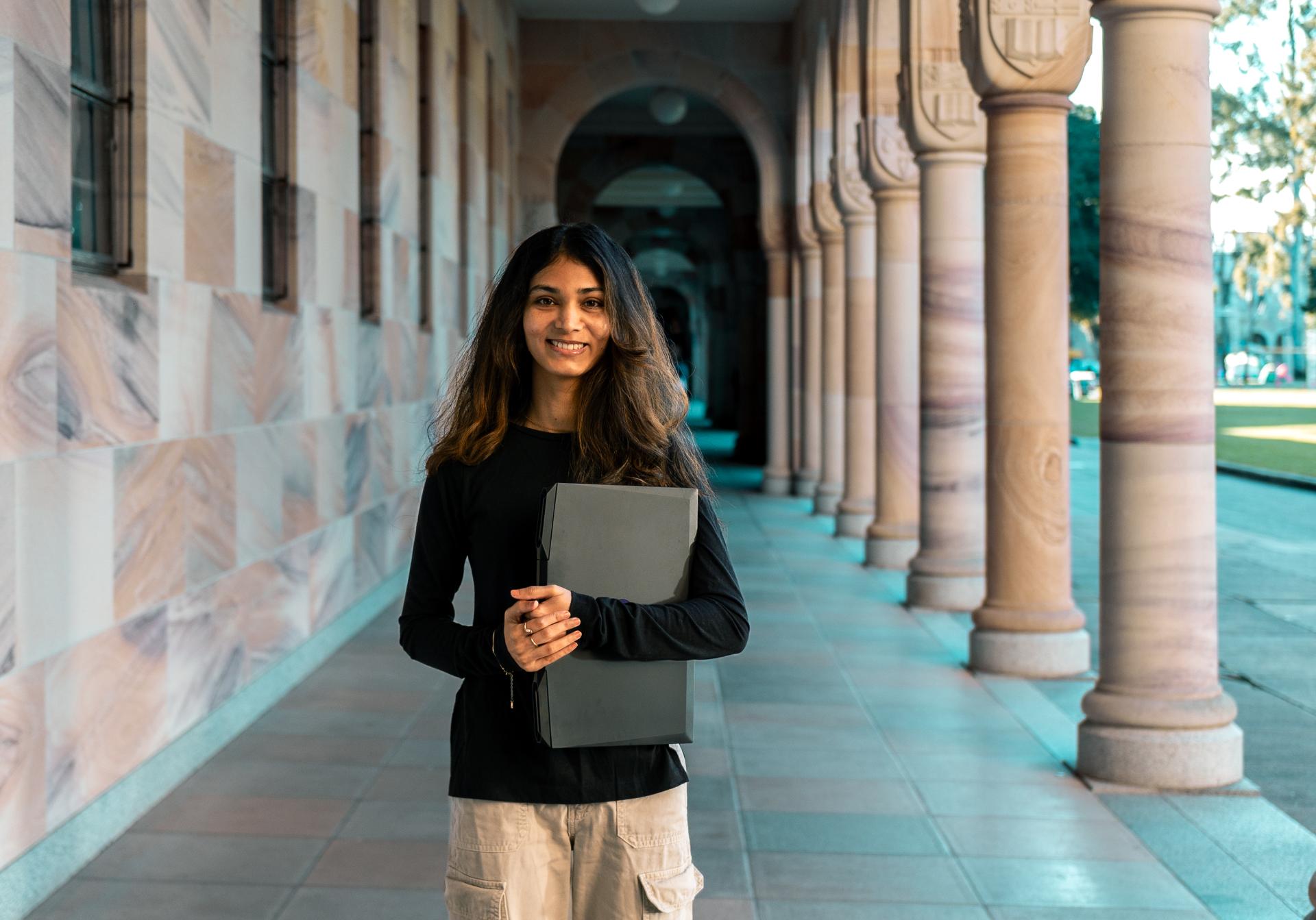 Female student standing in a corridor.